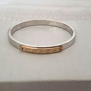 Coach bangle, silver and gold tone hinged bracelet.